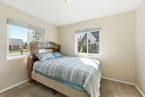 Bedroom with carpet floors and baseboards