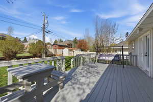 Wooden terrace with a storage unit and a residential view
