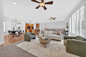 Living area featuring a chandelier and light colored carpet