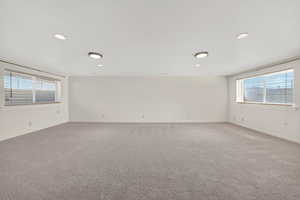 Carpeted empty room featuring plenty of natural light and recessed lighting