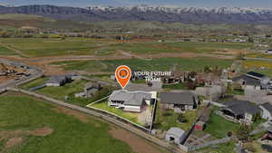 Aerial view of property's location with property boundaries highlighted, a mountainous background, and nearby suburban area