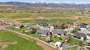 Aerial view of property's location featuring mountains and nearby suburban area