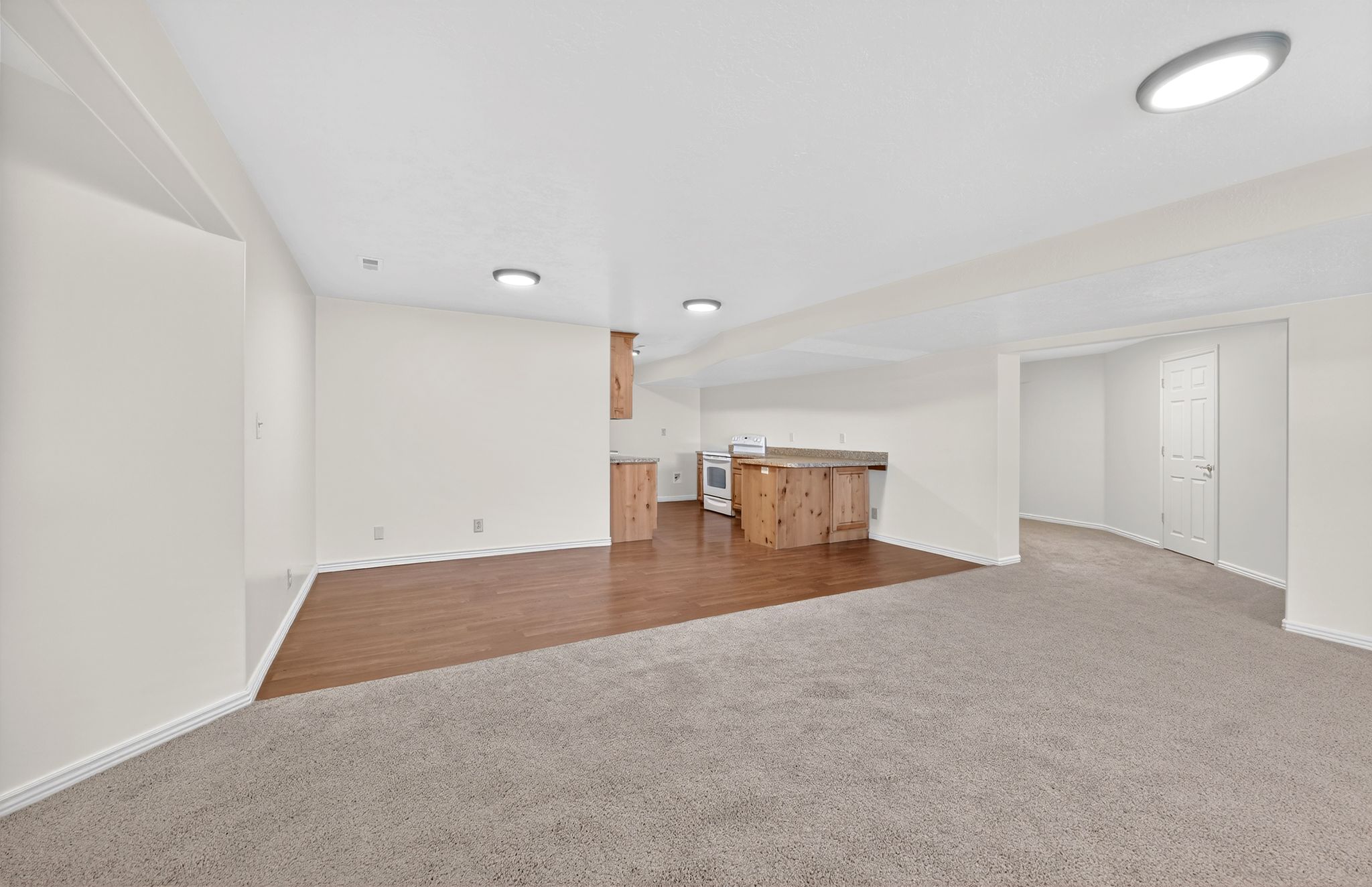 Finished below grade area with dark carpet and bar area