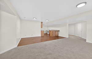 Finished below grade area with dark carpet and bar area