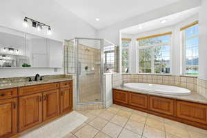 Bathroom featuring a shower stall, a garden tub, light tile patterned floors, vanity, and recessed lighting