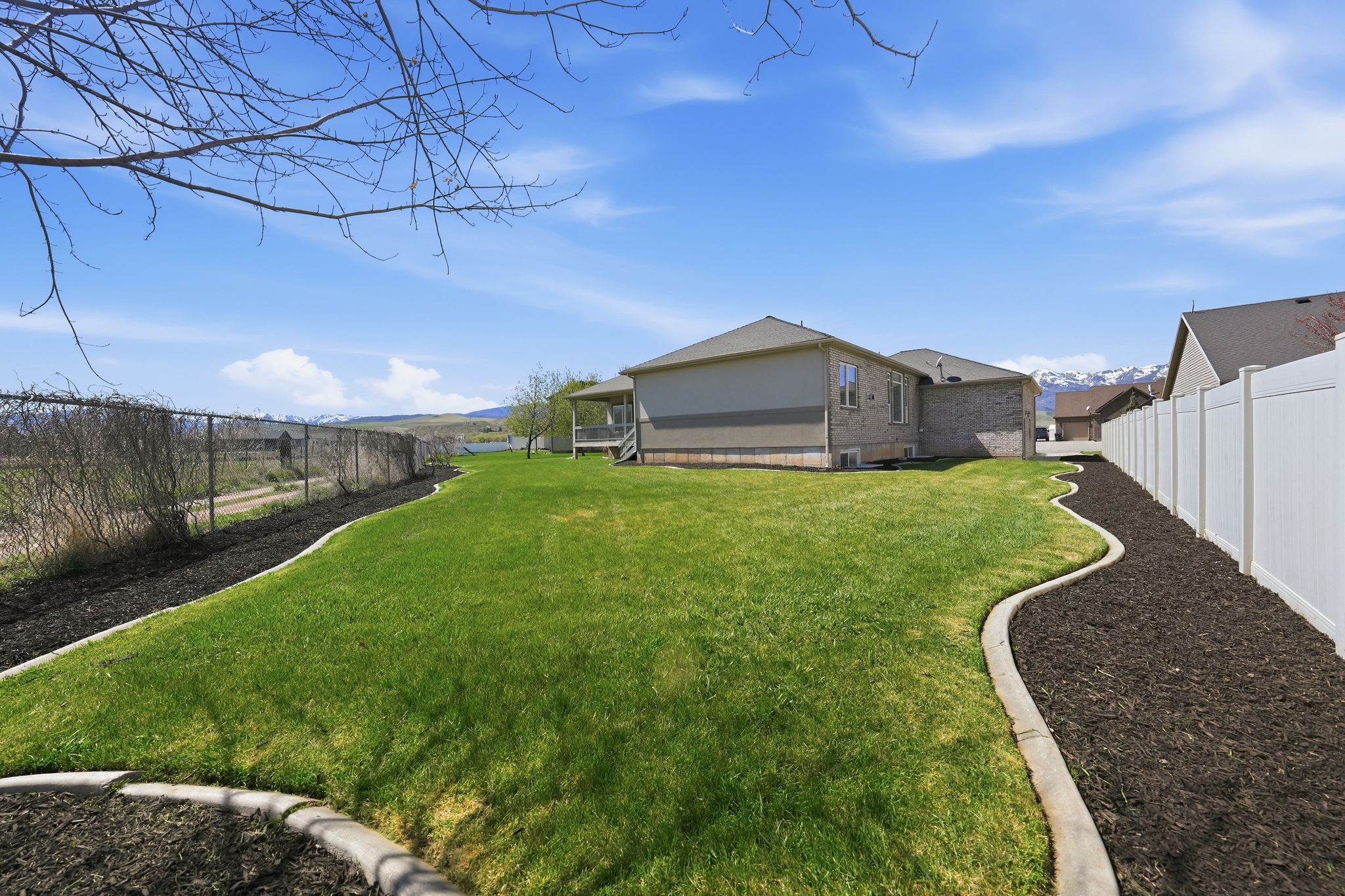 Fenced backyard featuring a mountain view