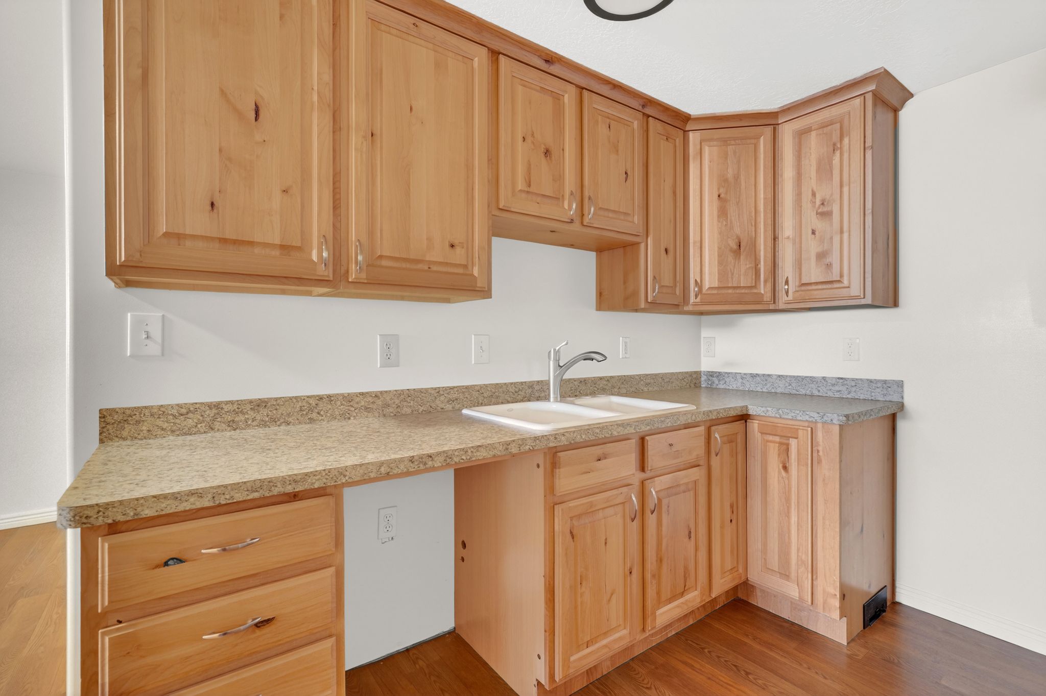Kitchen with light wood finish cabinets, light countertops, and light wood-type flooring