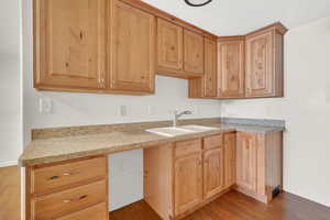 Kitchen with light wood finish cabinets, light countertops, and light wood-type flooring