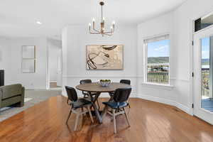 Dining area featuring light wood finished floors and suspended lighting