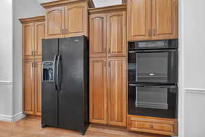 Kitchen featuring black appliances and light wood-type flooring