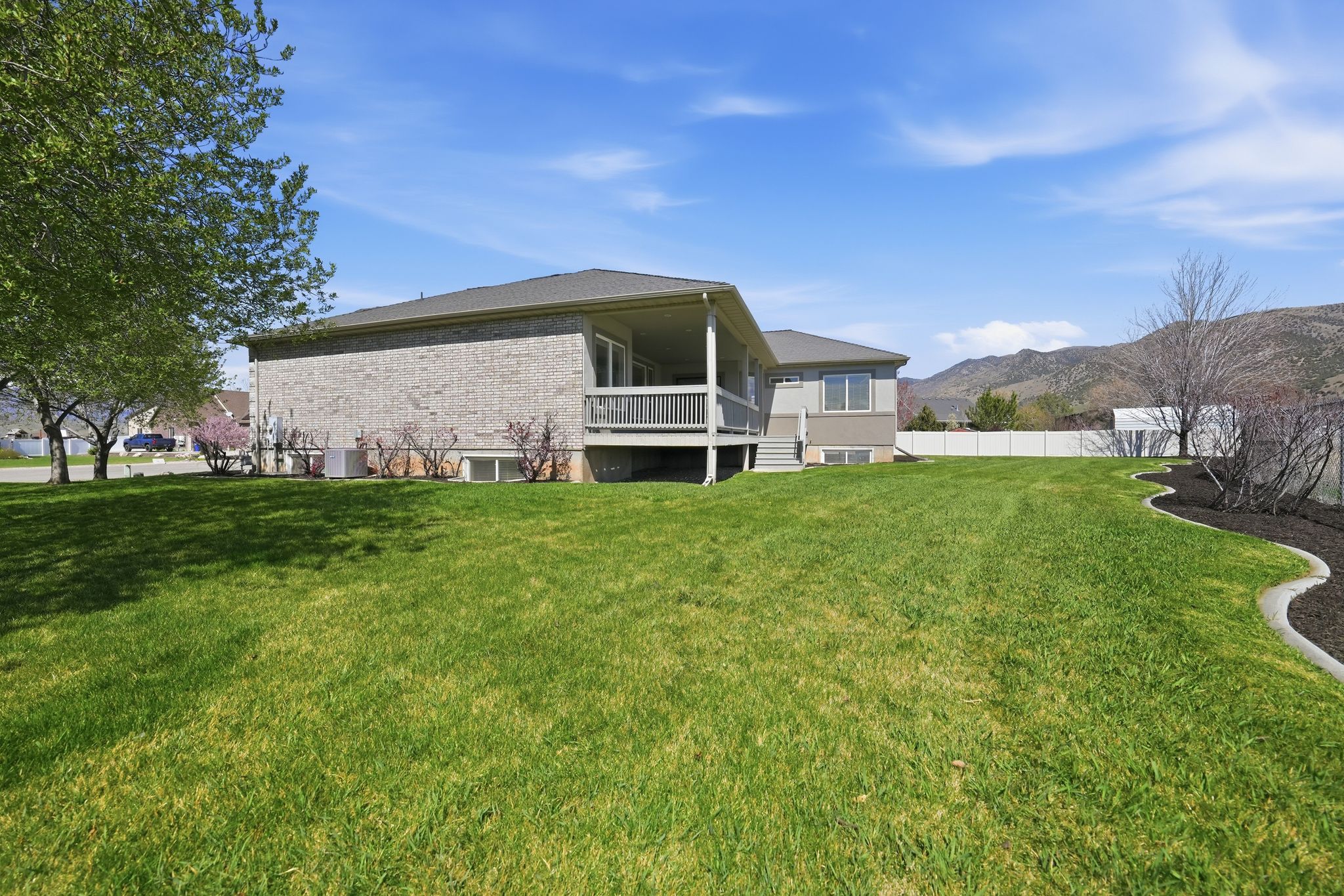 Back of property featuring a mountain view and brick siding