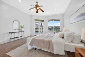 Carpeted bedroom with access to outside, ornamental molding, ceiling fan, recessed lighting, and a mountain view