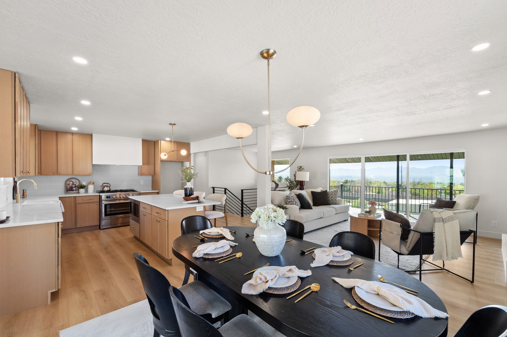 Dining area with light wood-style floors, recessed lighting, and a textured ceiling