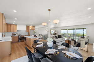 Dining area with light wood-style floors, recessed lighting, and a textured ceiling