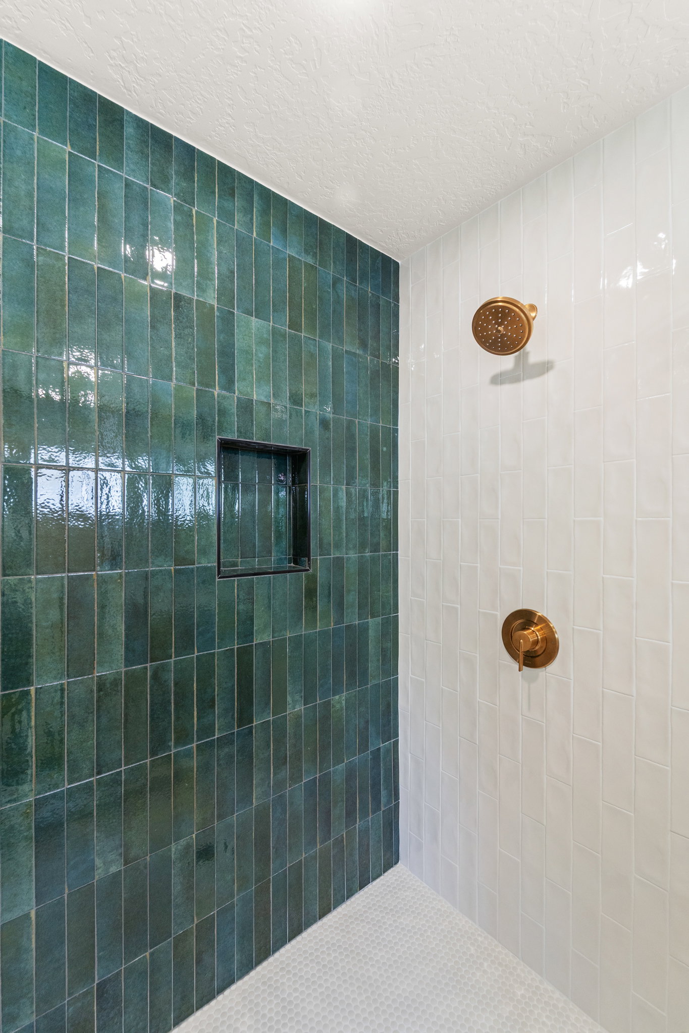 Full bathroom featuring a textured ceiling and a tile shower