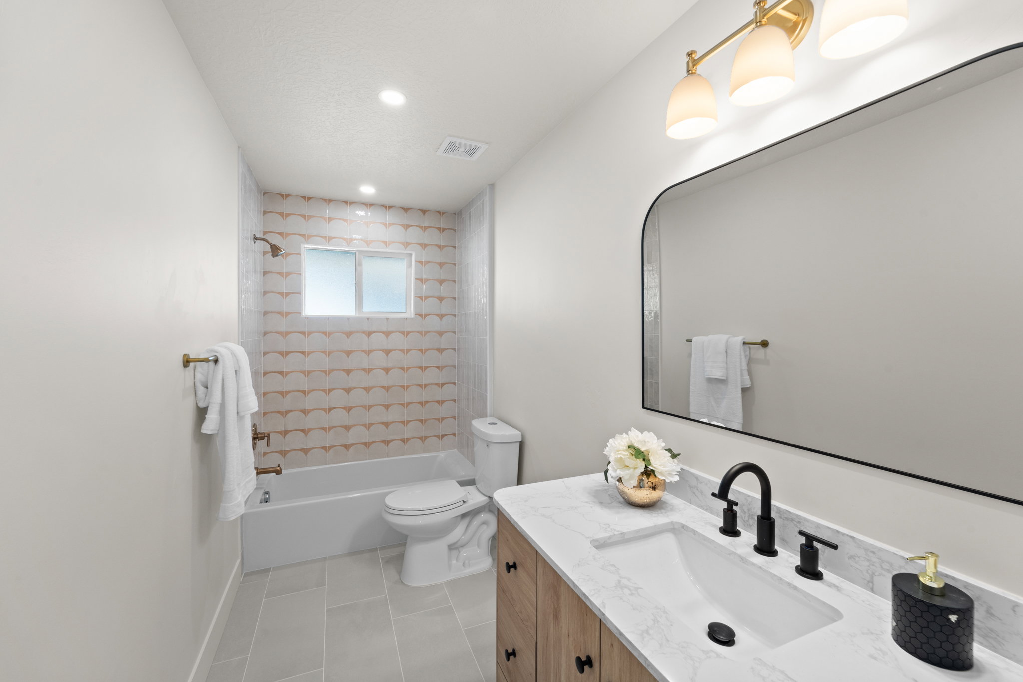 Full bathroom with vanity, bathing tub / shower combination, light tile patterned flooring, and recessed lighting