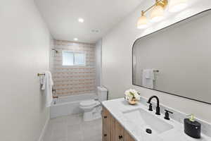 Full bathroom with vanity, bathing tub / shower combination, light tile patterned flooring, and recessed lighting