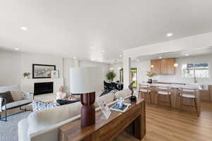 Living room featuring plenty of natural light, light wood-style floors, and recessed lighting