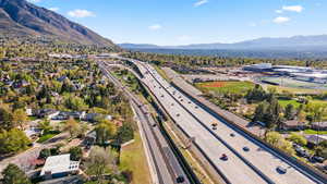 Aerial view of residential area featuring a highway and mountains