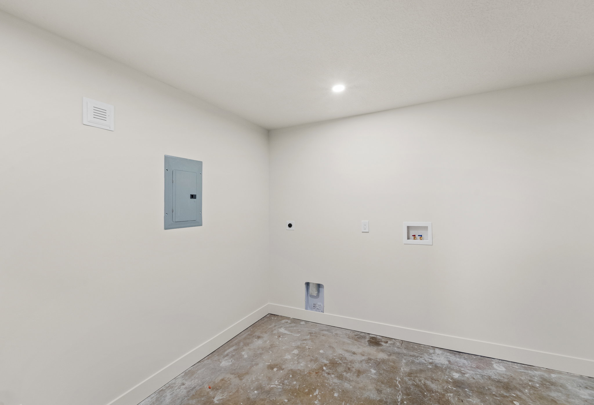Laundry room with concrete flooring, electric panel, washer hookup, electric dryer hookup, and recessed lighting