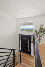 Entryway with light wood-style floors, a textured ceiling, and a mountain view