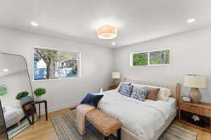 Bedroom featuring light wood-style flooring, recessed lighting, and a textured ceiling