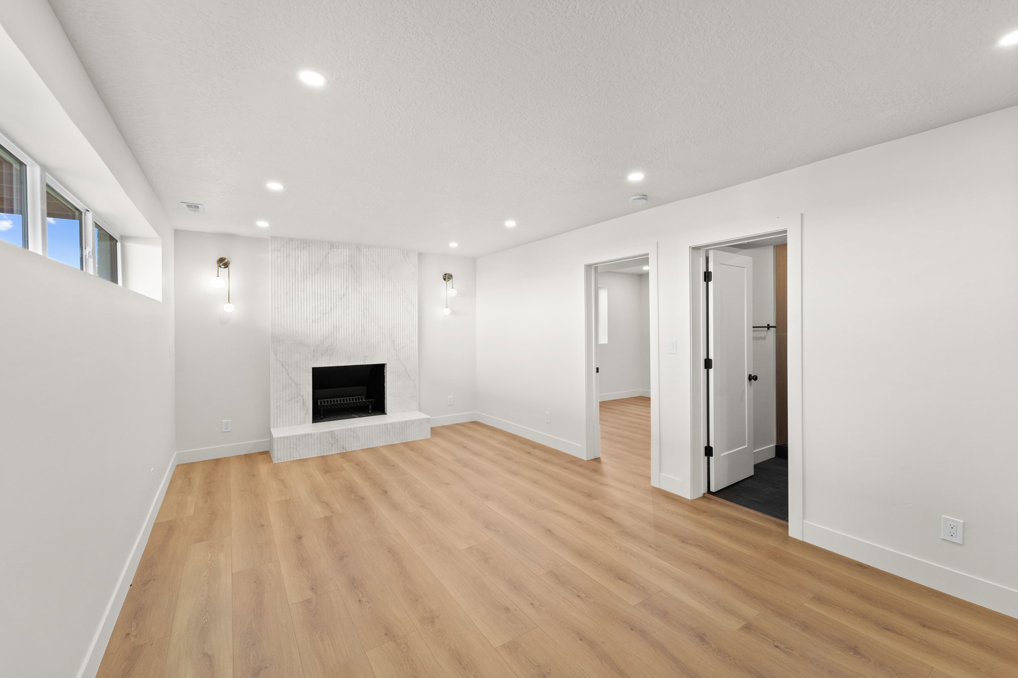 Unfurnished living room with recessed lighting, a fireplace, and light wood-style floors