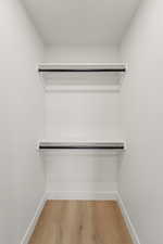 Walk in closet featuring light wood-type flooring