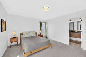 Bedroom featuring carpet floors and baseboards