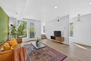Living room with light wood-style floors and recessed lighting