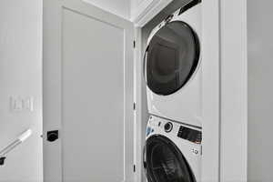 Laundry area with stacked washer and dryer