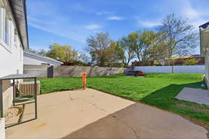 Fenced backyard with a patio area