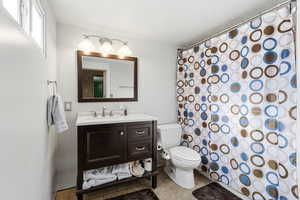Bathroom featuring vanity, curtained shower, and light tile patterned flooring