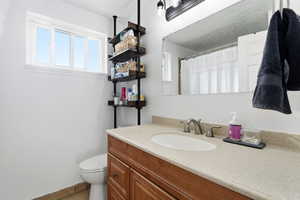 Full bath with vanity and a shower with shower curtain