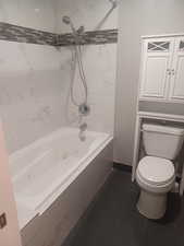 Master Bathroom with a combined bath / shower with jetted tub and baseboards