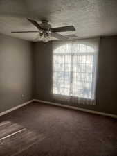 2nd bedroom upstairs. Carpeted featuring ceiling fan and a textured ceiling