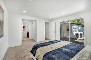 Bedroom with carpet flooring, access to outside, recessed lighting, and ensuite bathroom