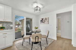 Dining area with light wood-style floors and baseboards