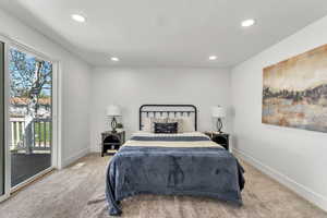 Bedroom with light colored carpet, access to outside, and recessed lighting