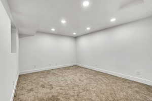 Carpeted spare room featuring baseboards and recessed lighting