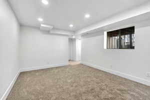 Finished below grade area featuring carpet flooring and recessed lighting