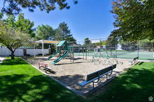 View of jungle gym featuring a tennis court
