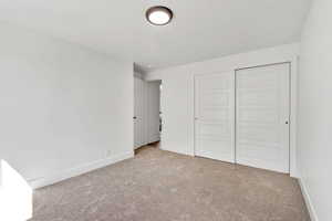 Unfurnished bedroom featuring a closet and carpet floors