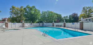 Community pool with a patio and a community hot tub