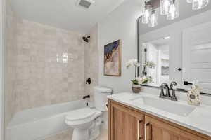 Full bath featuring vanity and washtub / shower combination