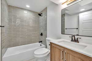 Bathroom featuring vanity, bathtub / shower combination, and recessed lighting