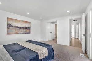 Bedroom featuring light carpet and recessed lighting