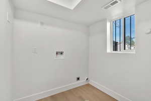 Laundry room featuring washer hookup, light wood-style flooring, and hookup for an electric dryer