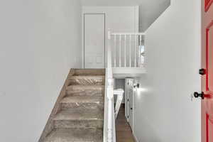 Stairway featuring wood finished floors