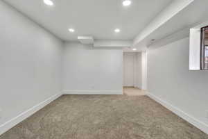 Finished basement featuring recessed lighting and light carpet